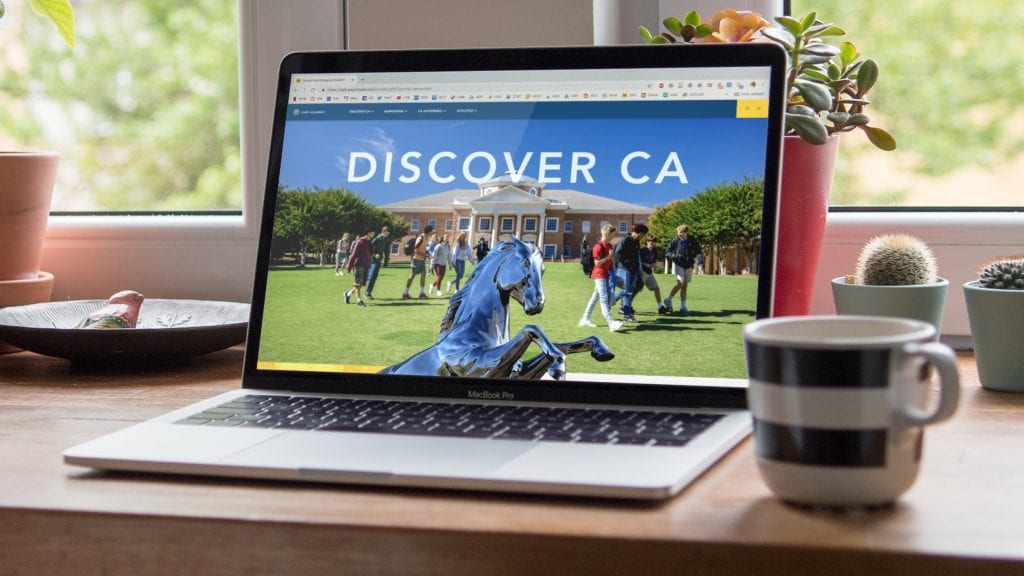 Cary Academy homepage on a laptop